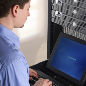 IT professional working at a server rack station