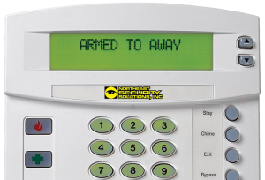 An alarm keypad displaying an "Armed to Away" message