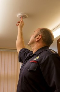 inspector testing a smoke detector