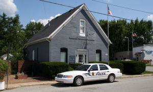 A police car parked in front of a business.