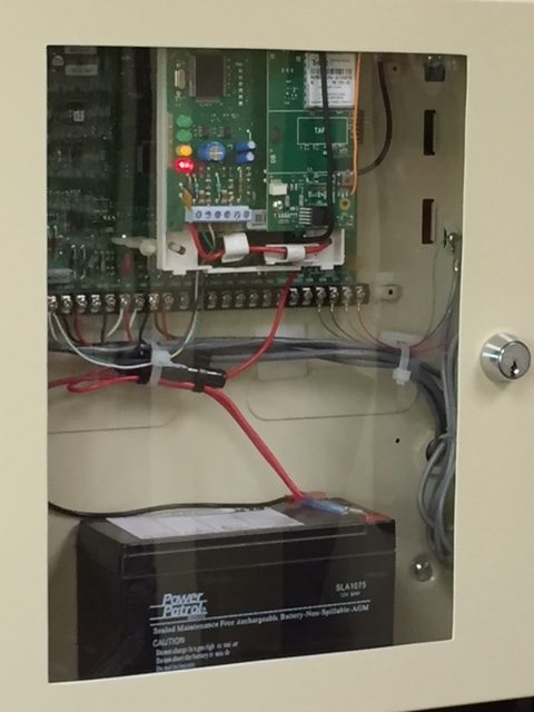 A security system panel with a backup battery.