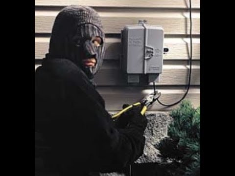 A burglar cutting a phone line.