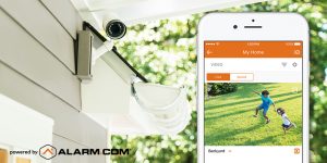 An Alarm.com outdoor camera monitoring a customer's yard.