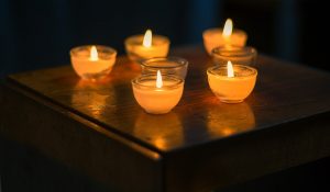 Several lit candles on a table