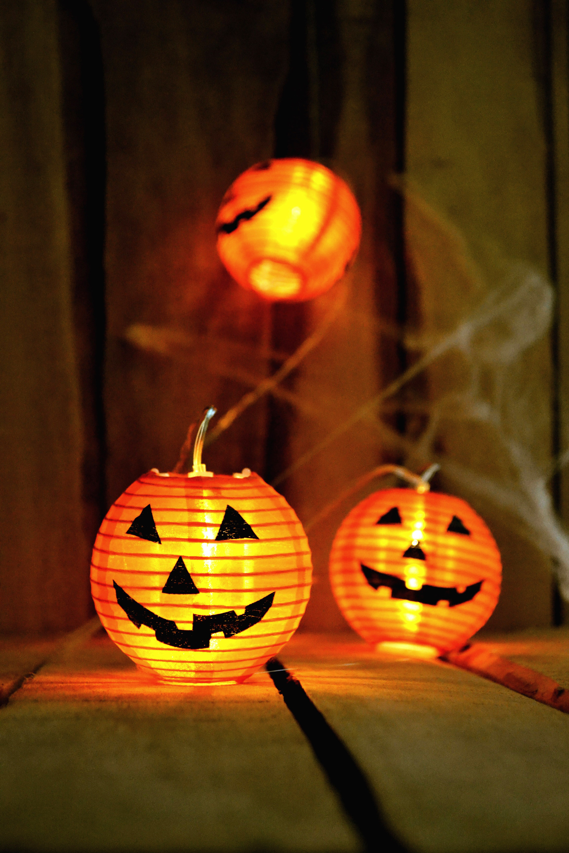 Three Jack-o-Lanterns and a spider's web Halloween decorations.