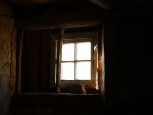 A basement window with light streaming through