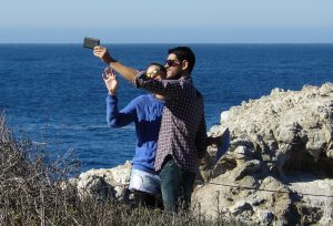 Two people taking a selfie on a beach.