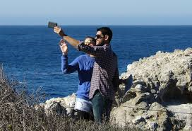 Two people taking a selfie on a beach.