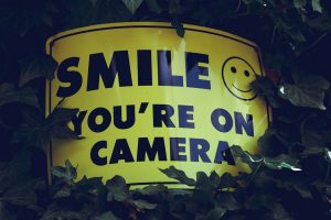 A sign reading "Smile, You're on Camera"