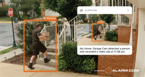 An Alarm.com smart camera video alert showing a person approaching a door.