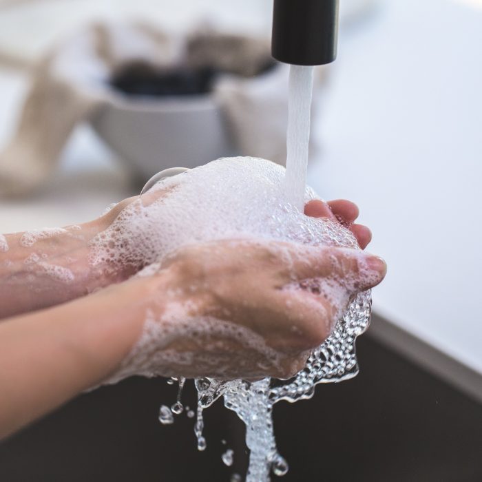 Hands being washed in a sink
