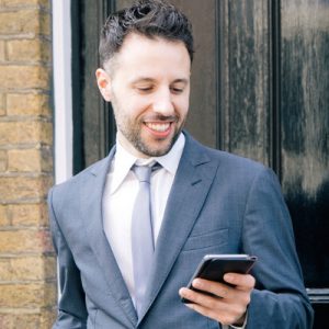 A man in a suit holding a phone