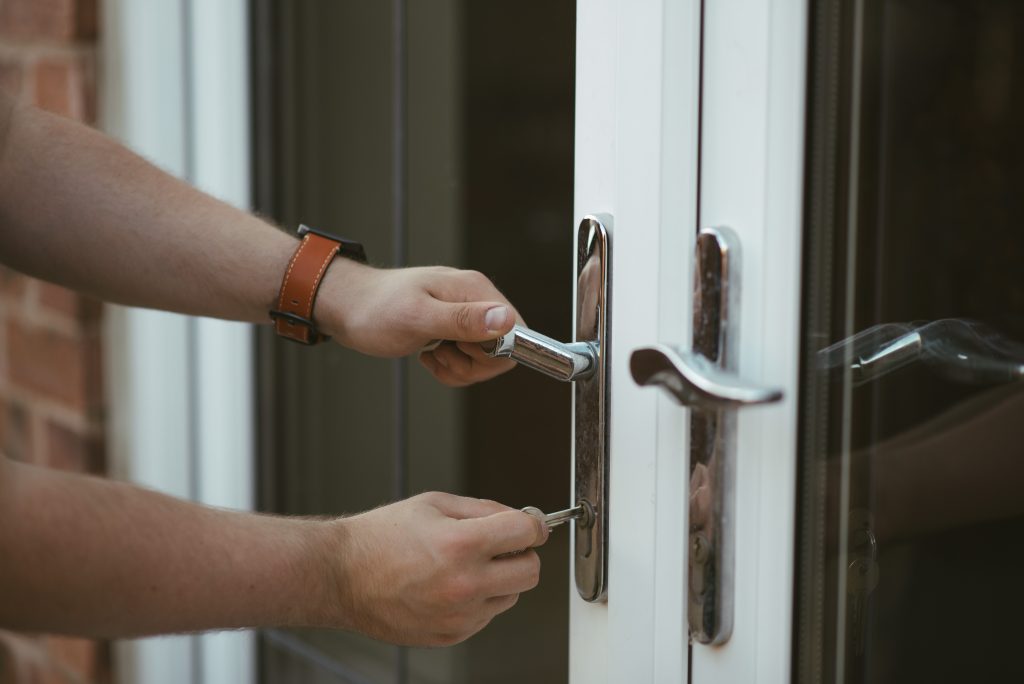 A person unlocking a door. 