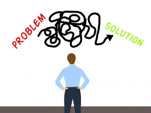 A man looking at a board with the words "problem" and "solution" on it