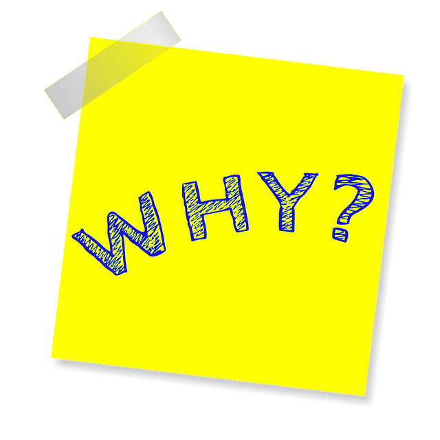 A yellow note with tape and the word "why?"